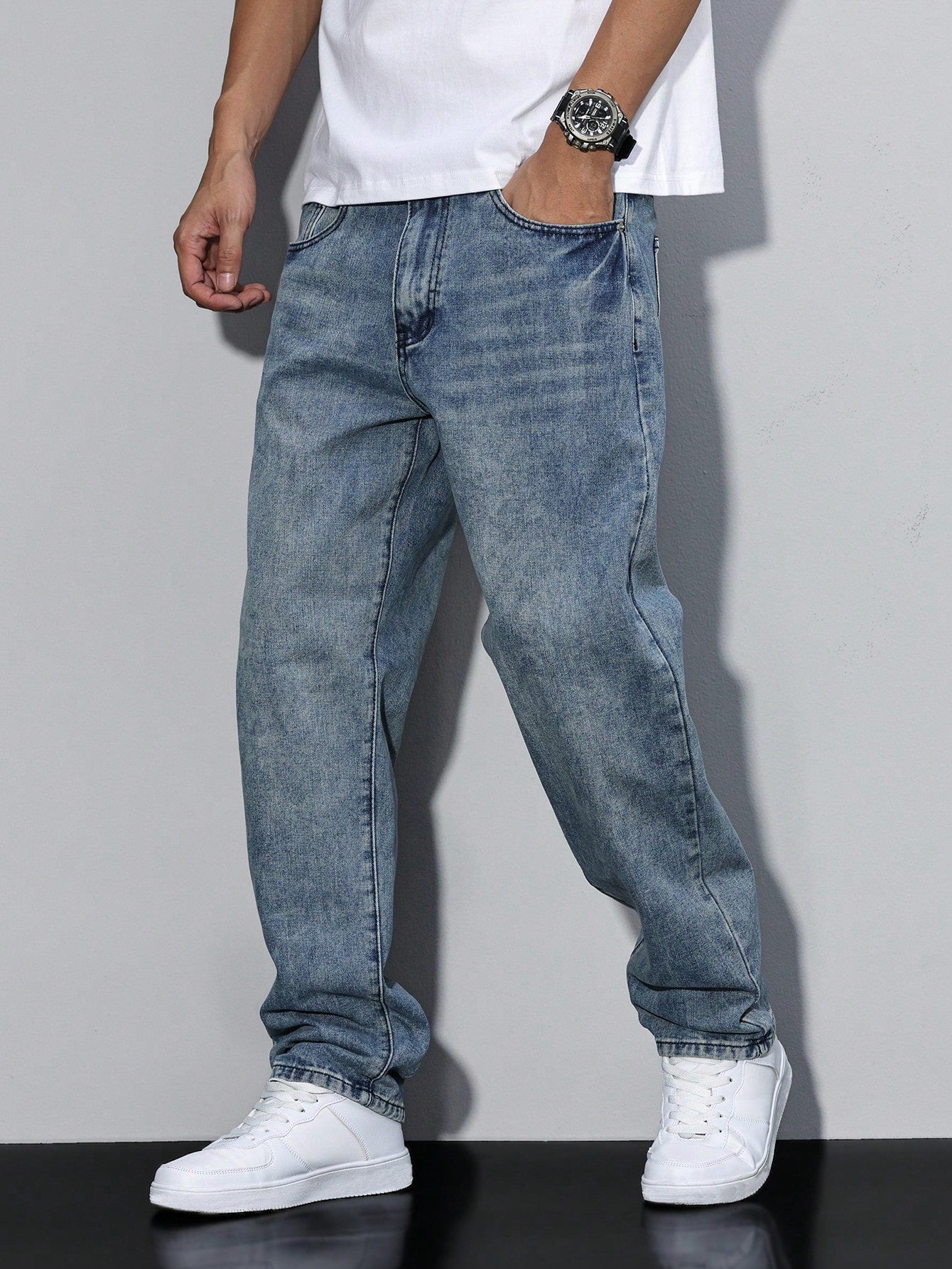 Men's loose-fitting jeans with straight legs in a solid color, displayed flat on a white background. 4