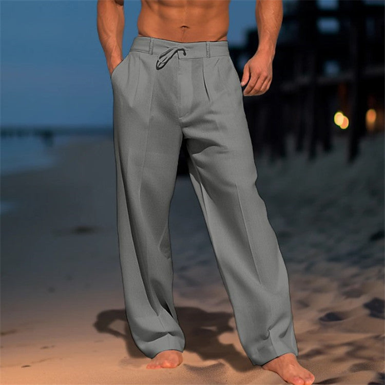 Men's loose spring trousers with an adjustable waist, displayed hanging on a wooden hanger against a neutral background. 1