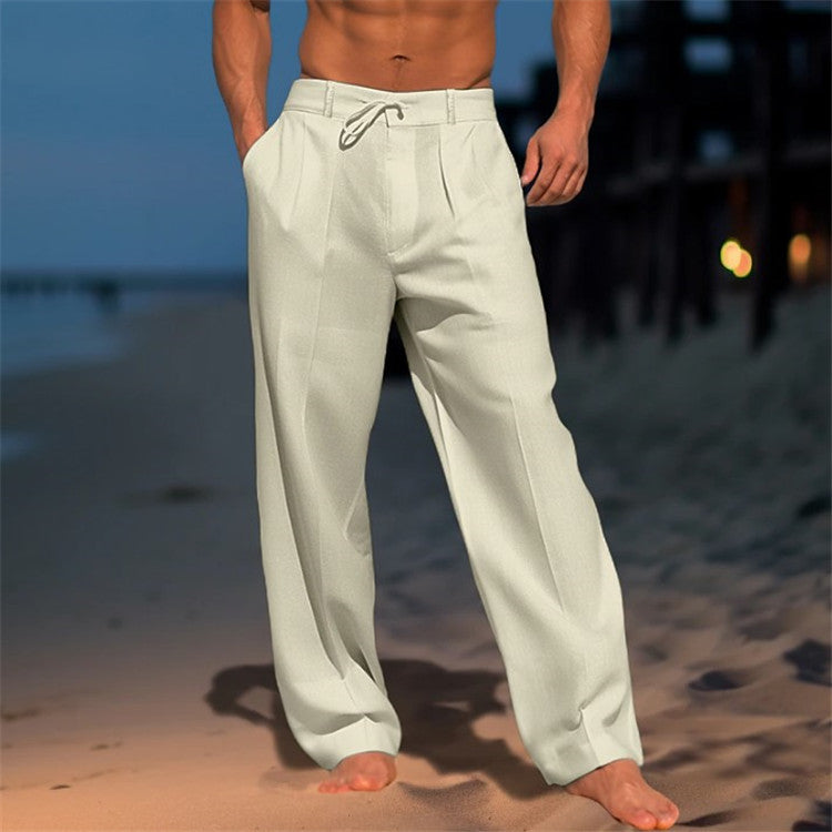 Men's loose spring trousers with an adjustable waist, displayed hanging on a wooden hanger against a neutral background. 2