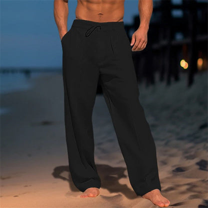 Men's loose spring trousers with an adjustable waist, displayed hanging on a wooden hanger against a neutral background. 3