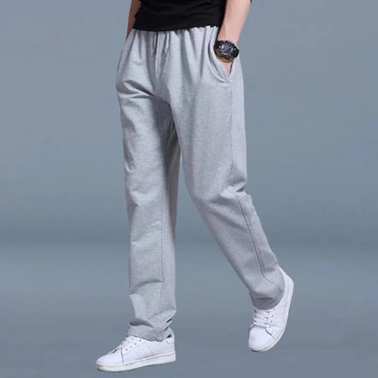 Men's sweatpants with wide legs and an elastic waistband, displayed on a neutral background. 2
