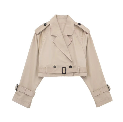 Short women's trench coat with a belt and double-breasted closure, displayed on a mannequin. 0