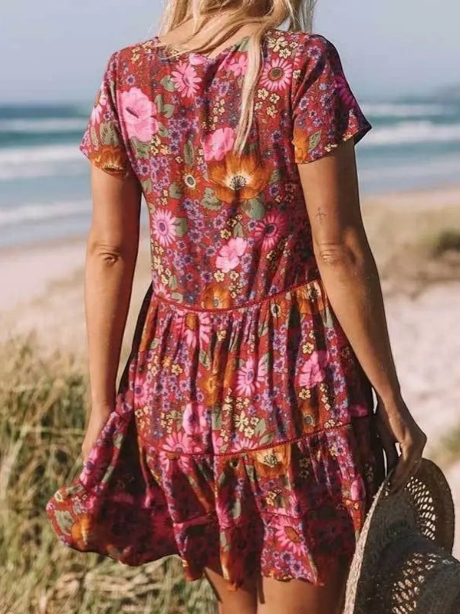 A short-sleeve mini dress with a boho design, featuring a relaxed fit and a flowing silhouette, suitable for summer wear. 2