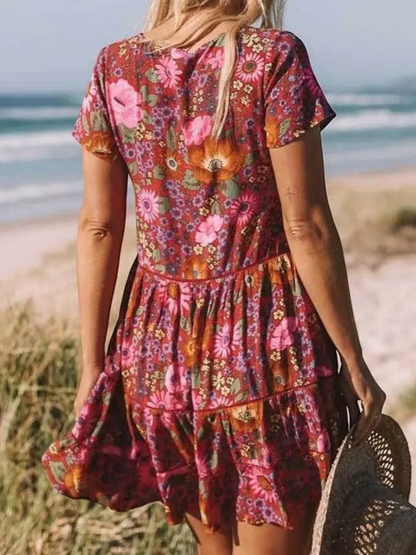 A short-sleeve mini dress with a boho design, featuring a relaxed fit and a flowing silhouette, suitable for summer wear. 2