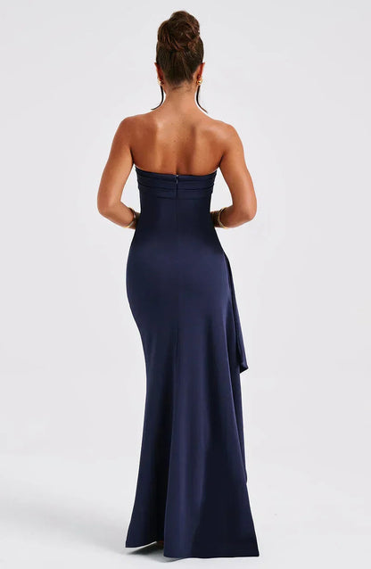 Maxi dress without straps featuring a high slit, designed for formal occasions such as weddings. 1