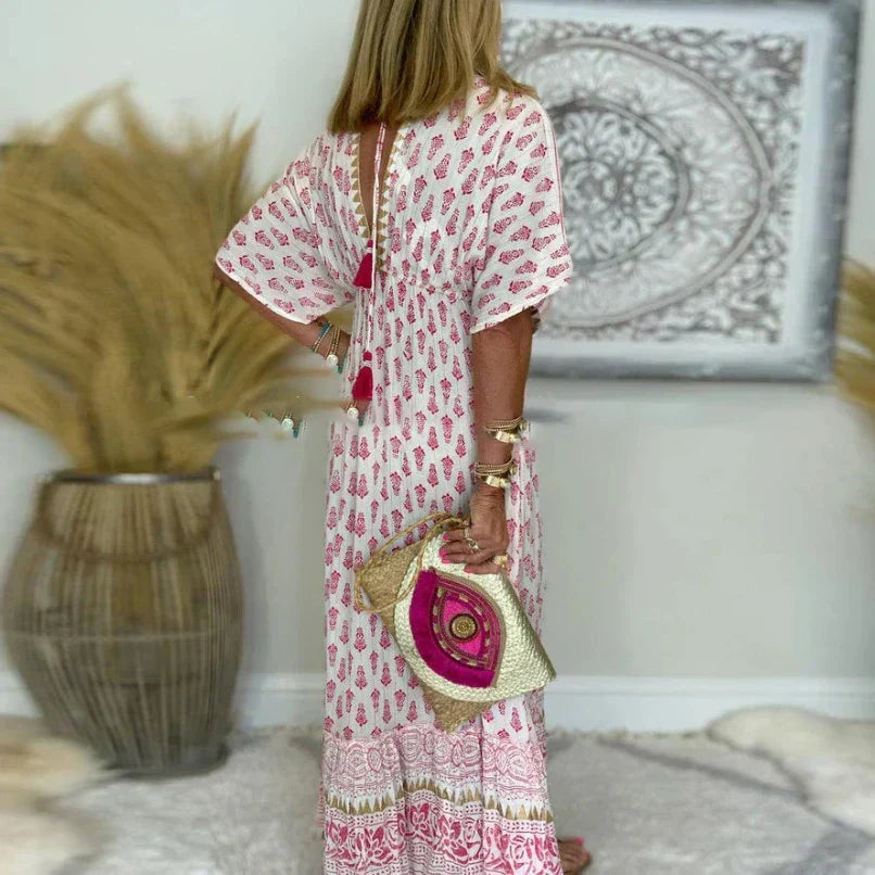 Maxi dress with a V-neckline and Boho print, featuring a flowing design suitable for formal events. 2
