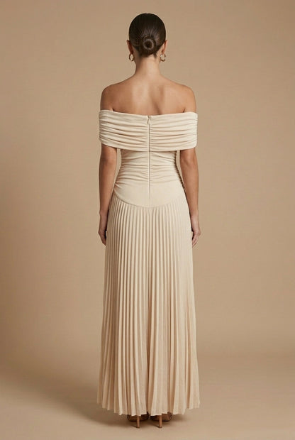 Maxi dress for women featuring off-the-shoulder sleeves and a pleated skirt, displayed on a mannequin. 1