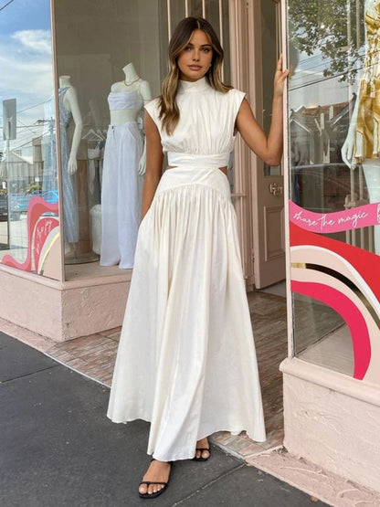 Maxi dress with a V-neckline and cut-out details, designed for formal events and summer gatherings. 1