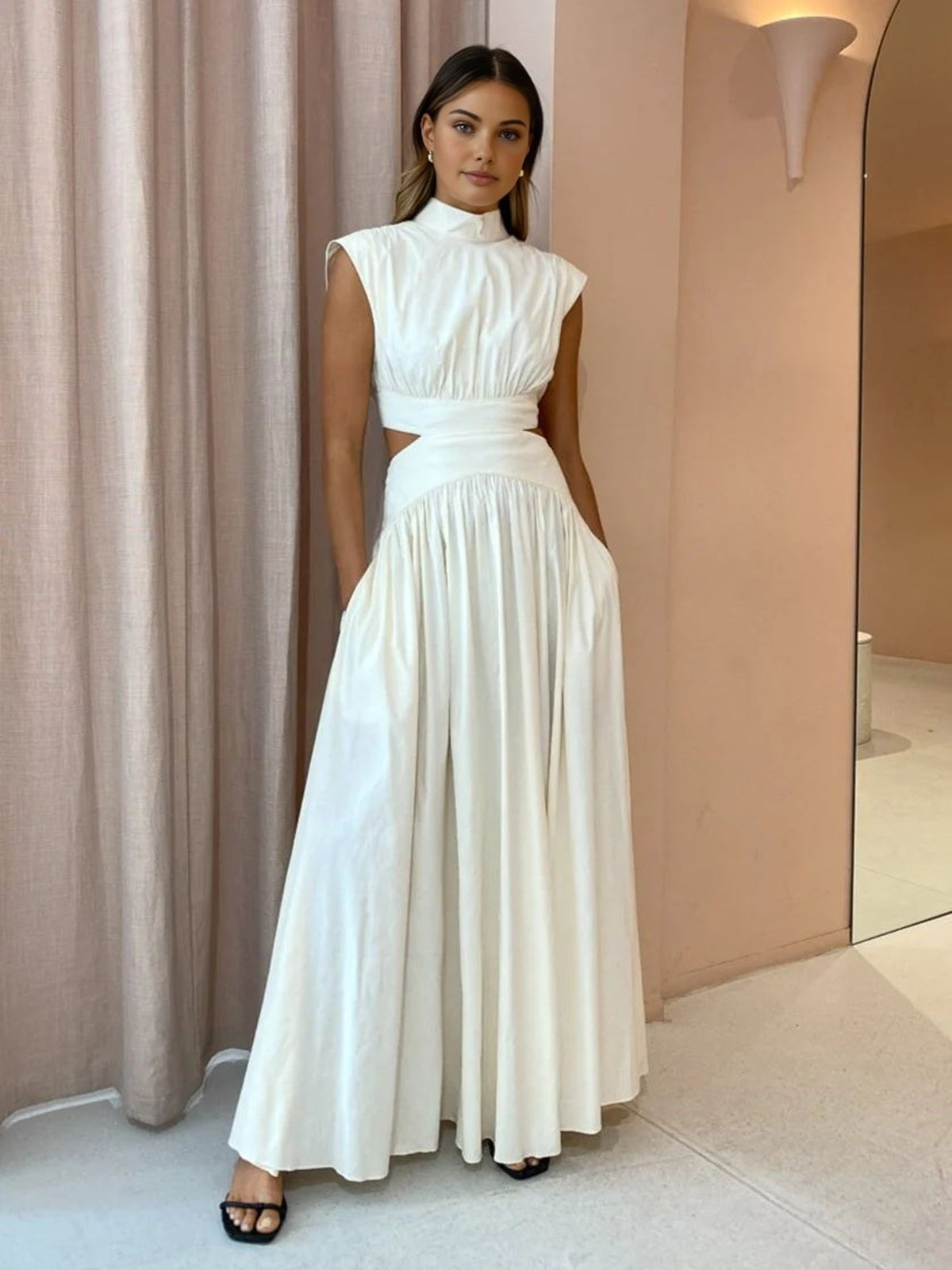 Maxi dress with a V-neckline and cut-out details, designed for formal events and summer gatherings. 2