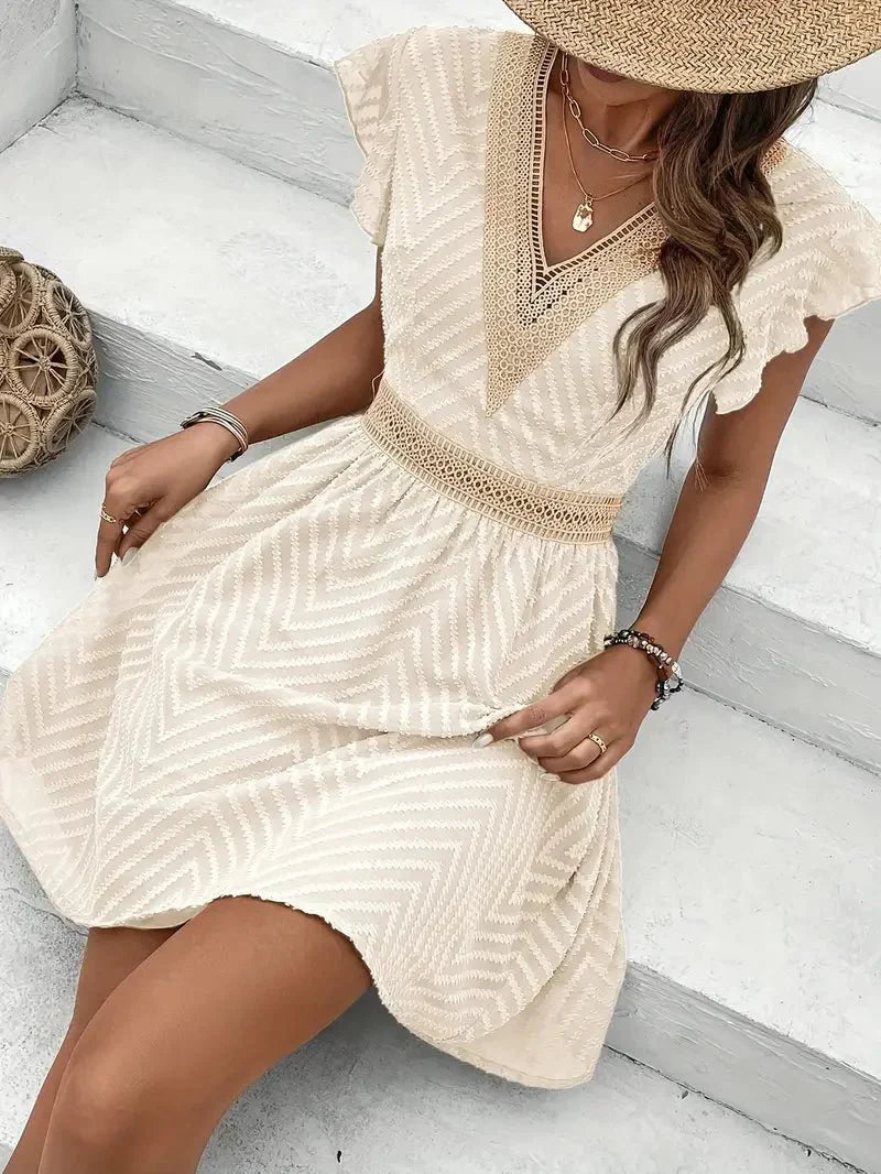 Mini A-line dress featuring a heart-shaped neckline, designed for formal events like weddings. 1