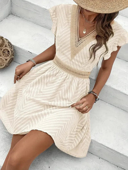 Mini A-line dress featuring a heart-shaped neckline, designed for formal events like weddings. 1