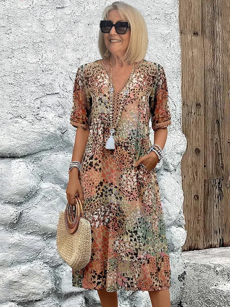 Woman's dress for weddings featuring a fitted design and vibrant pattern. 0