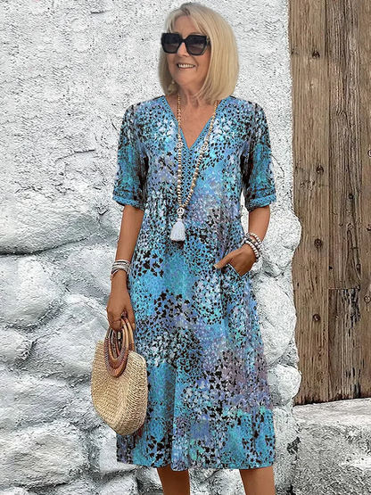 Woman's dress for weddings featuring a fitted design and vibrant pattern. 2