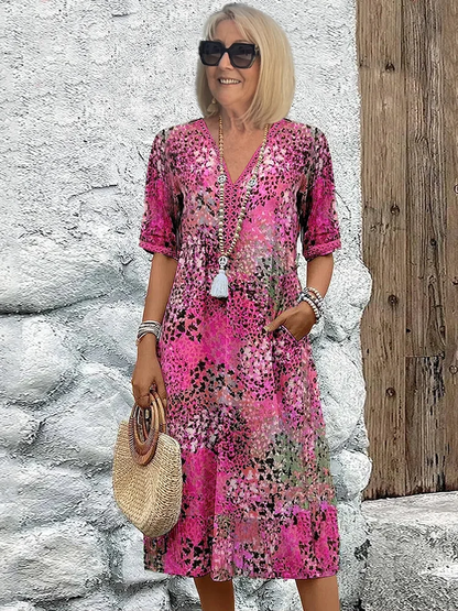 Woman's dress for weddings featuring a fitted design and vibrant pattern. 3