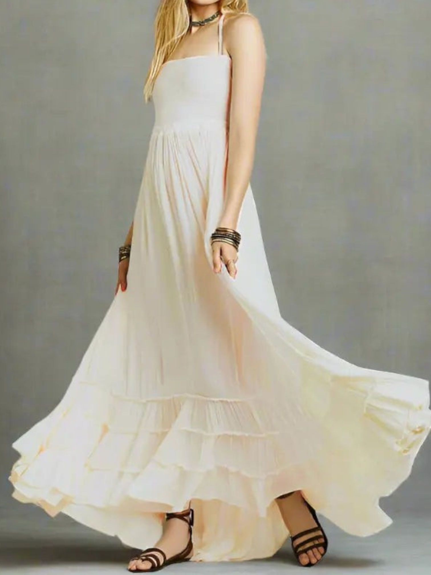 Maxi dress with backless design, featuring a tie neck and a thigh-high slit, displayed on a mannequin in a neutral setting. 0