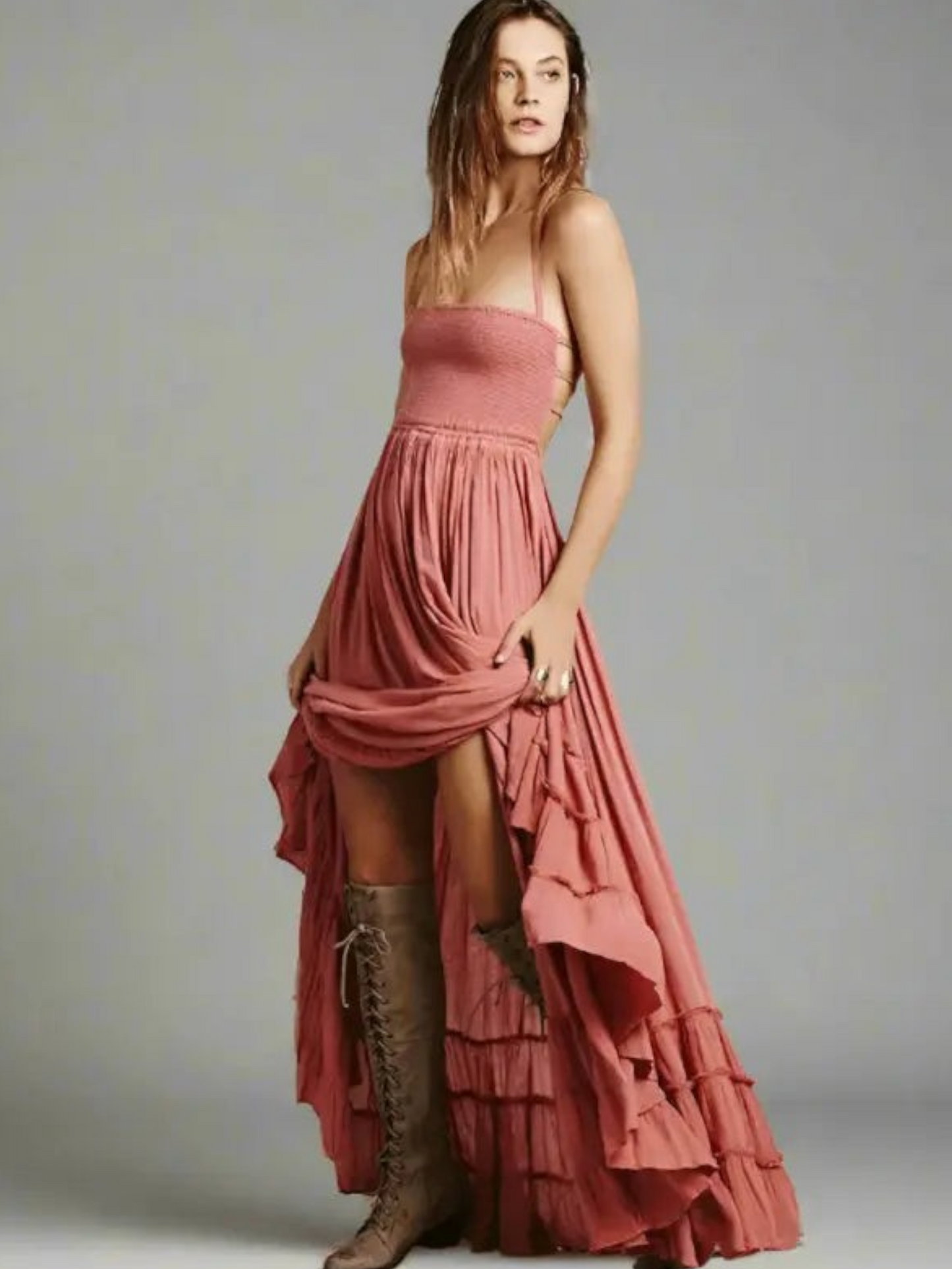 Maxi dress with backless design, featuring a tie neck and a thigh-high slit, displayed on a mannequin in a neutral setting. 1
