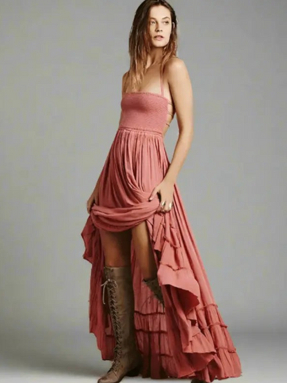 Maxi dress with backless design, featuring a tie neck and a thigh-high slit, displayed on a mannequin in a neutral setting. 1
