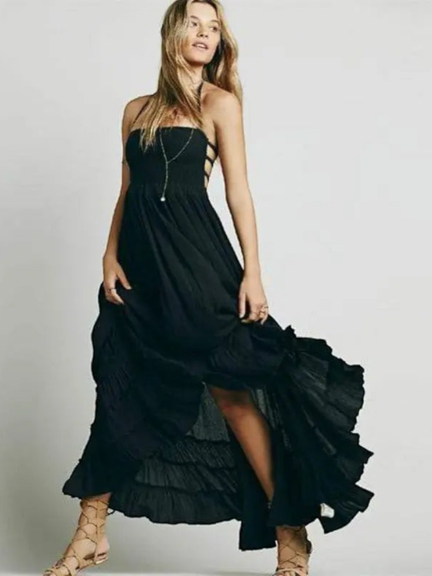 Maxi dress with backless design, featuring a tie neck and a thigh-high slit, displayed on a mannequin in a neutral setting. 4
