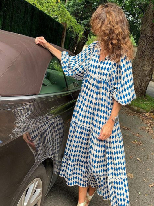 Maxi dress with long sleeves featuring a retro design, suitable for women attending weddings. The dress has a flowing silhouette and a classic pattern. 0