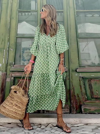 Maxi dress with long sleeves featuring a retro design, suitable for women attending weddings. The dress has a flowing silhouette and a classic pattern. 2