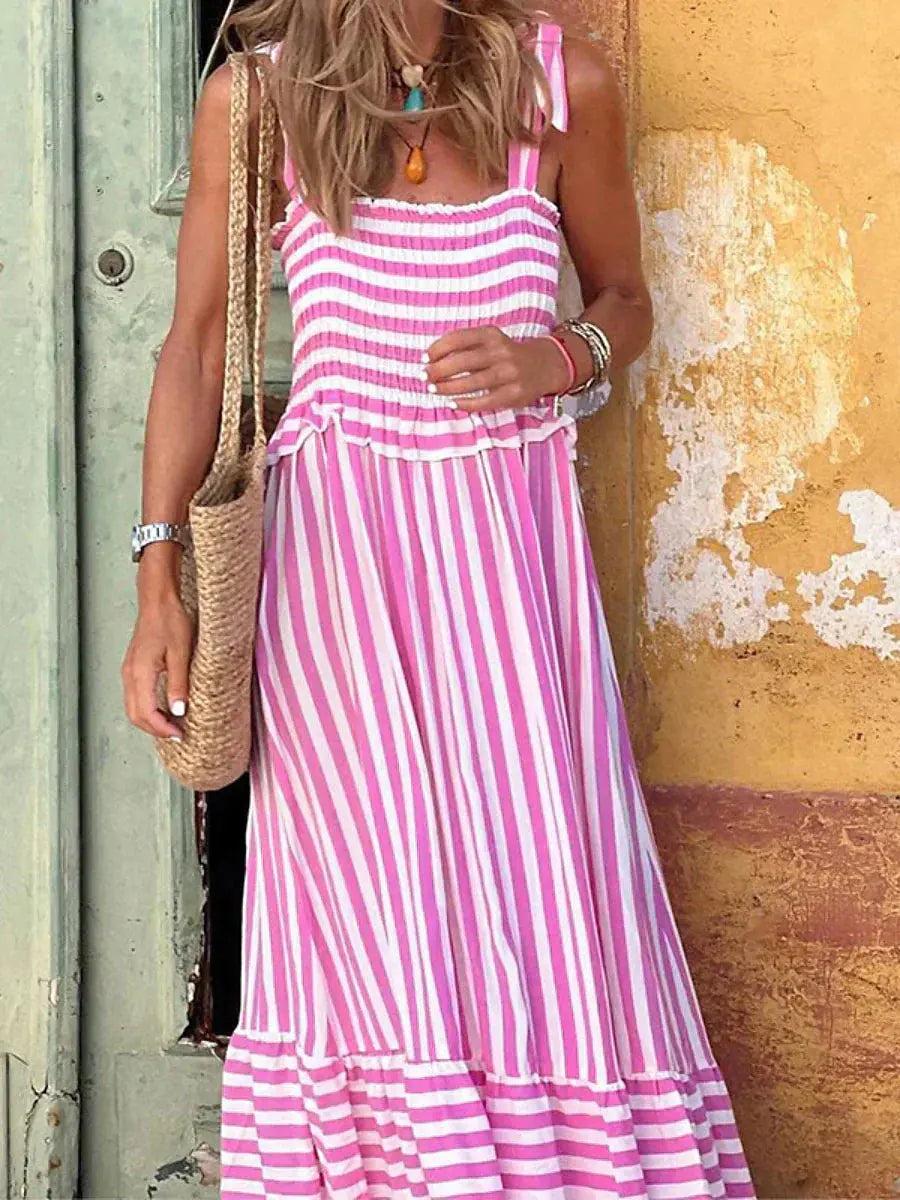 Maxi dress with a flowing silhouette and striped pattern, designed for weddings or summer outings, displayed on a hanger. 3