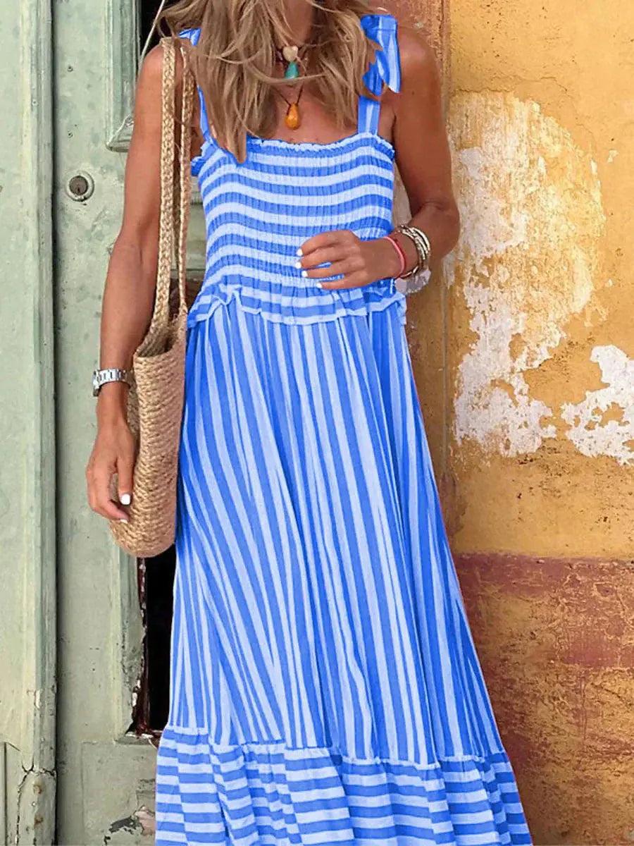 Maxi dress with a flowing silhouette and striped pattern, designed for weddings or summer outings, displayed on a hanger. 4