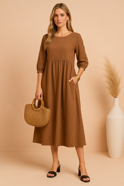 Midi dress with 3/4 sleeves and a defined waist, featuring a fitted bodice and flowing skirt. 3
