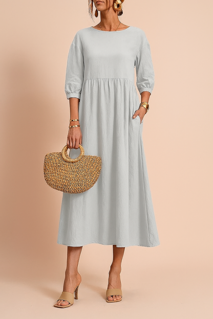 Midi dress with 3/4 sleeves and a defined waist, featuring a fitted bodice and flowing skirt. 7