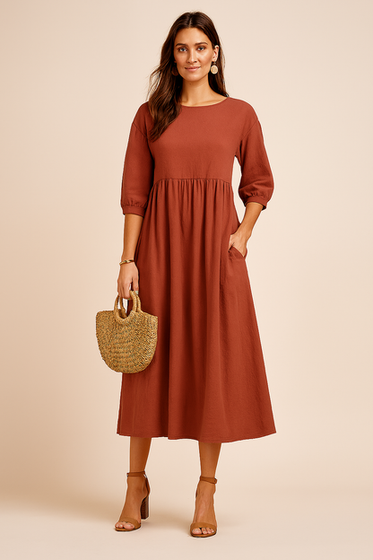 Midi dress with 3/4 sleeves and a defined waist, featuring a fitted bodice and flowing skirt. 8