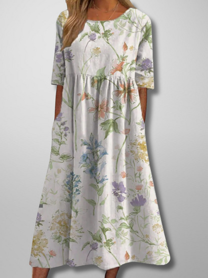 Midi dress featuring a floral pattern and delicate draping, designed for formal occasions like weddings. 3