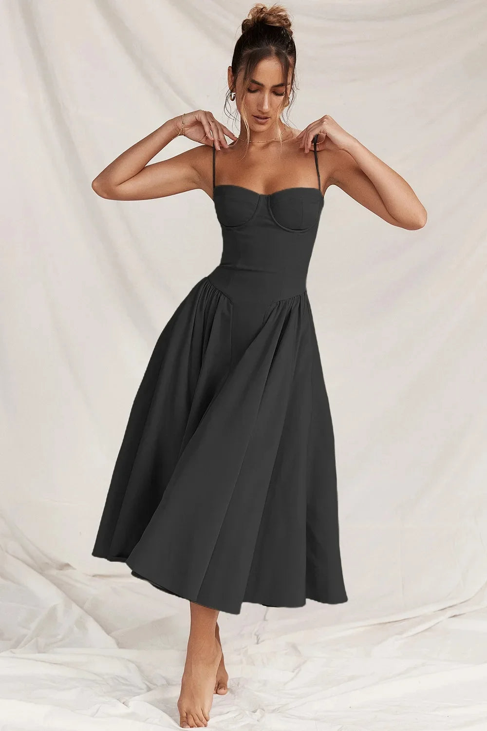 Midi evening dress featuring lace details and adjustable straps. The dress has a fitted bodice and a flowing skirt, showcasing elegant design elements. 5