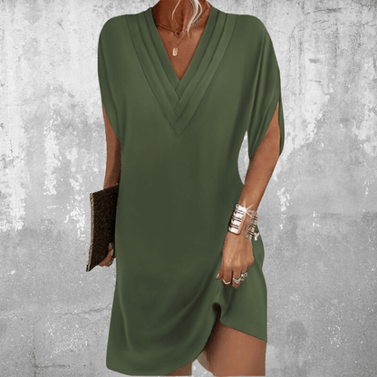 A women's casual summer dress featuring a V-neckline and a flowing silhouette, displayed on a mannequin against a neutral background. 0