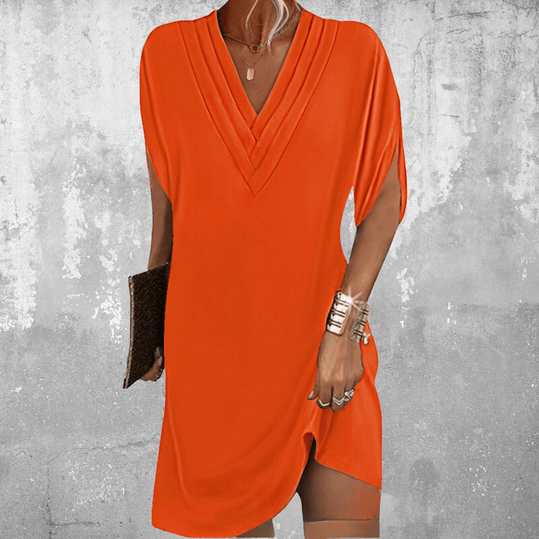 A women's casual summer dress featuring a V-neckline and a flowing silhouette, displayed on a mannequin against a neutral background. 4