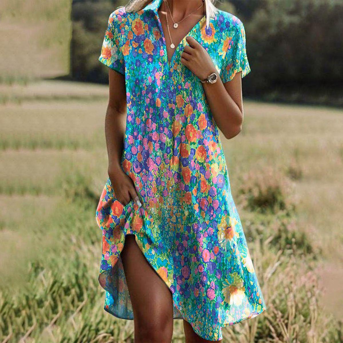 A women's summer dress featuring a vibrant pattern and a comfortable fit, displayed on a mannequin in a bright setting. 0