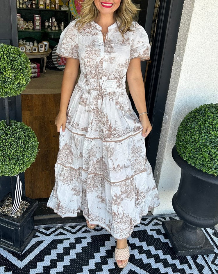 A women's maxi dress featuring a V-neckline and an A-line silhouette, displayed on a mannequin. The dress falls to the ankles, showcasing a flowing 1