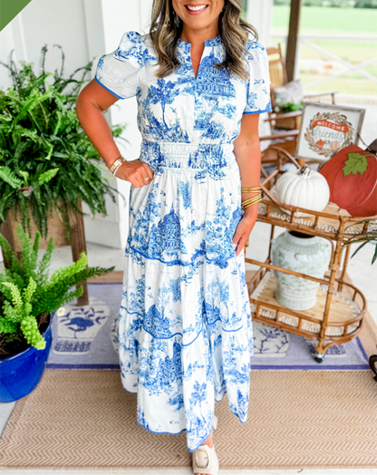 A women's maxi dress featuring a V-neckline and an A-line silhouette, displayed on a mannequin. The dress falls to the ankles, showcasing a flowing 2