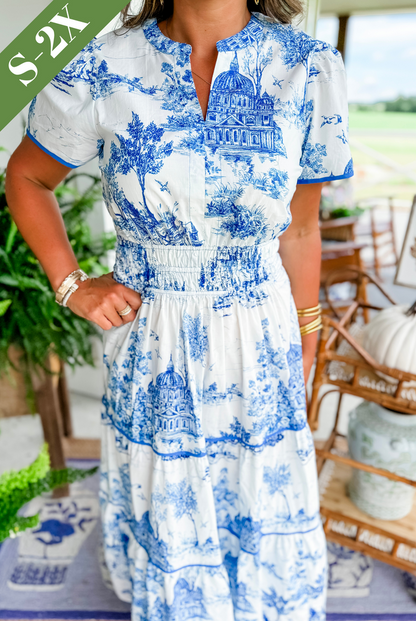 A women's maxi dress featuring a V-neckline and an A-line silhouette, displayed on a mannequin. The dress falls to the ankles, showcasing a flowing 3