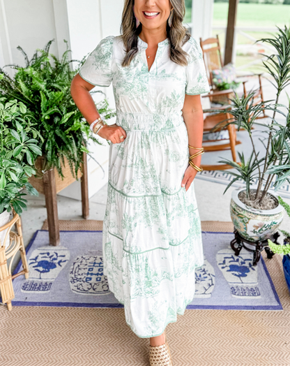 A women's maxi dress featuring a V-neckline and an A-line silhouette, displayed on a mannequin. The dress falls to the ankles, showcasing a flowing 6