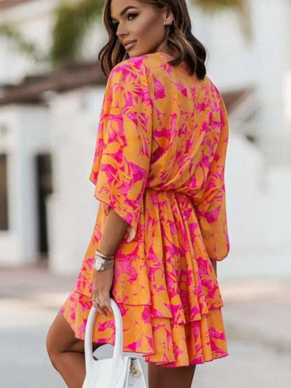 Women's mini dress featuring floral ruffles along the neckline and hem, designed with short sleeves and a flowy silhouette. 2