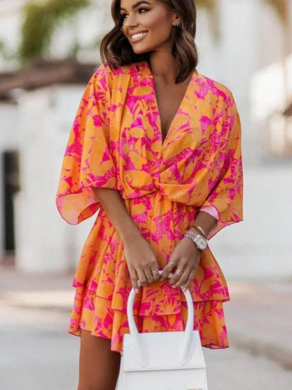 Women's mini dress featuring floral ruffles along the neckline and hem, designed with short sleeves and a flowy silhouette. 3