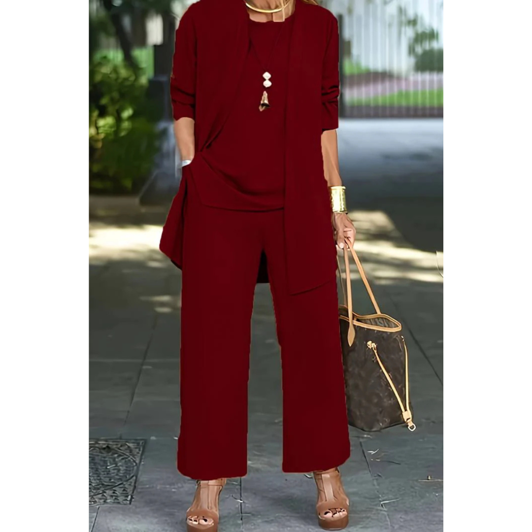 Three-piece women's casual set featuring a top, pants, and cardigan arranged neatly. The top has short sleeves, the pants are full-length, and the 2
