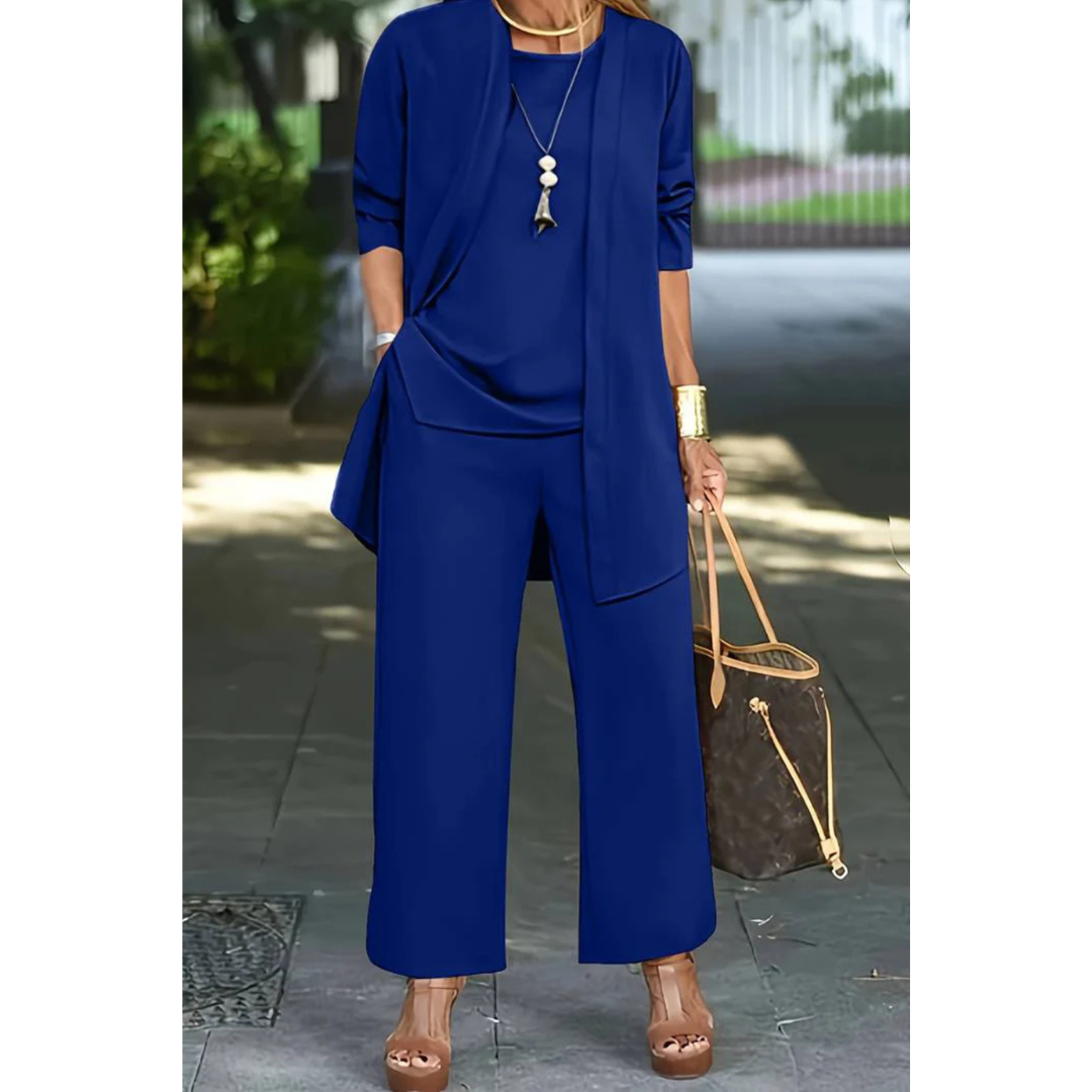 Three-piece women's casual set featuring a top, pants, and cardigan arranged neatly. The top has short sleeves, the pants are full-length, and the 3