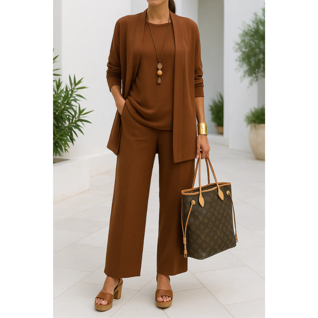Three-piece women's casual set featuring a top, pants, and cardigan arranged neatly. The top has short sleeves, the pants are full-length, and the 4