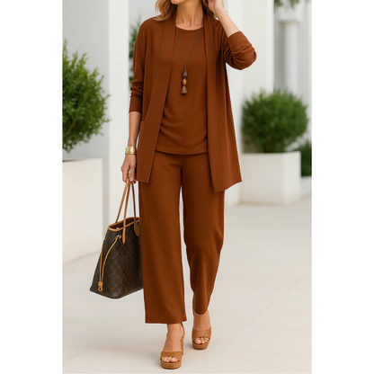Three-piece women's casual set featuring a top, pants, and cardigan arranged neatly. The top has short sleeves, the pants are full-length, and the 5