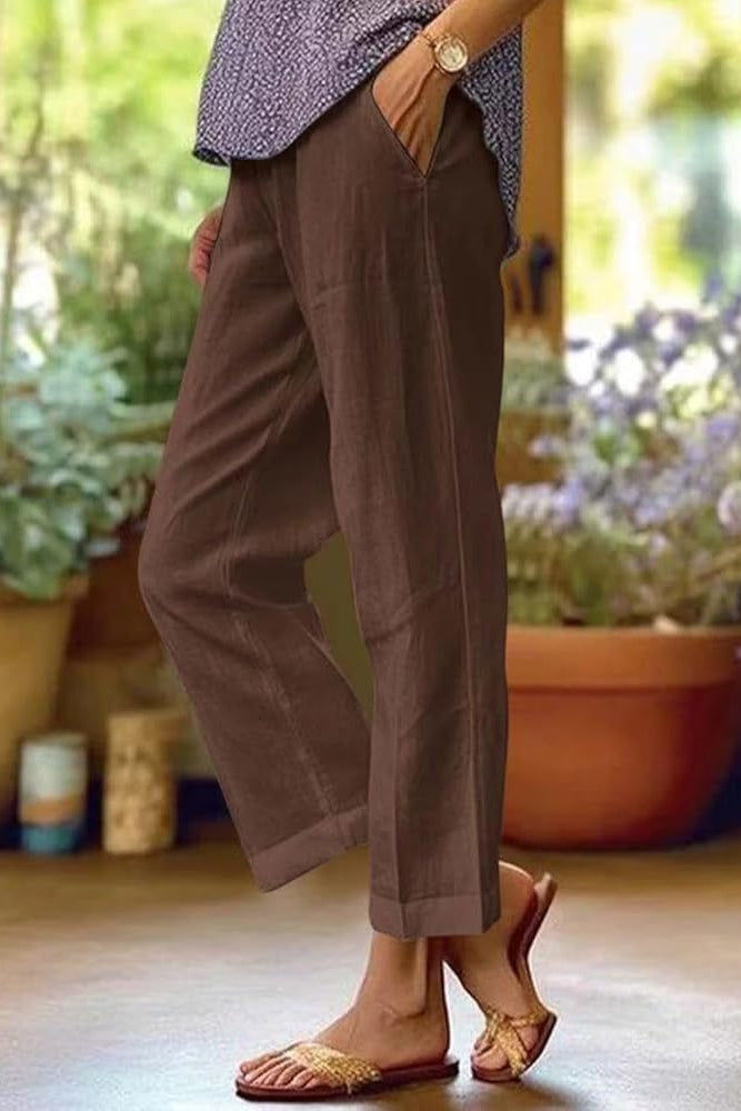 Loose-fitting summer women's trousers made from breathable fabric, featuring a relaxed design and side pockets. 1